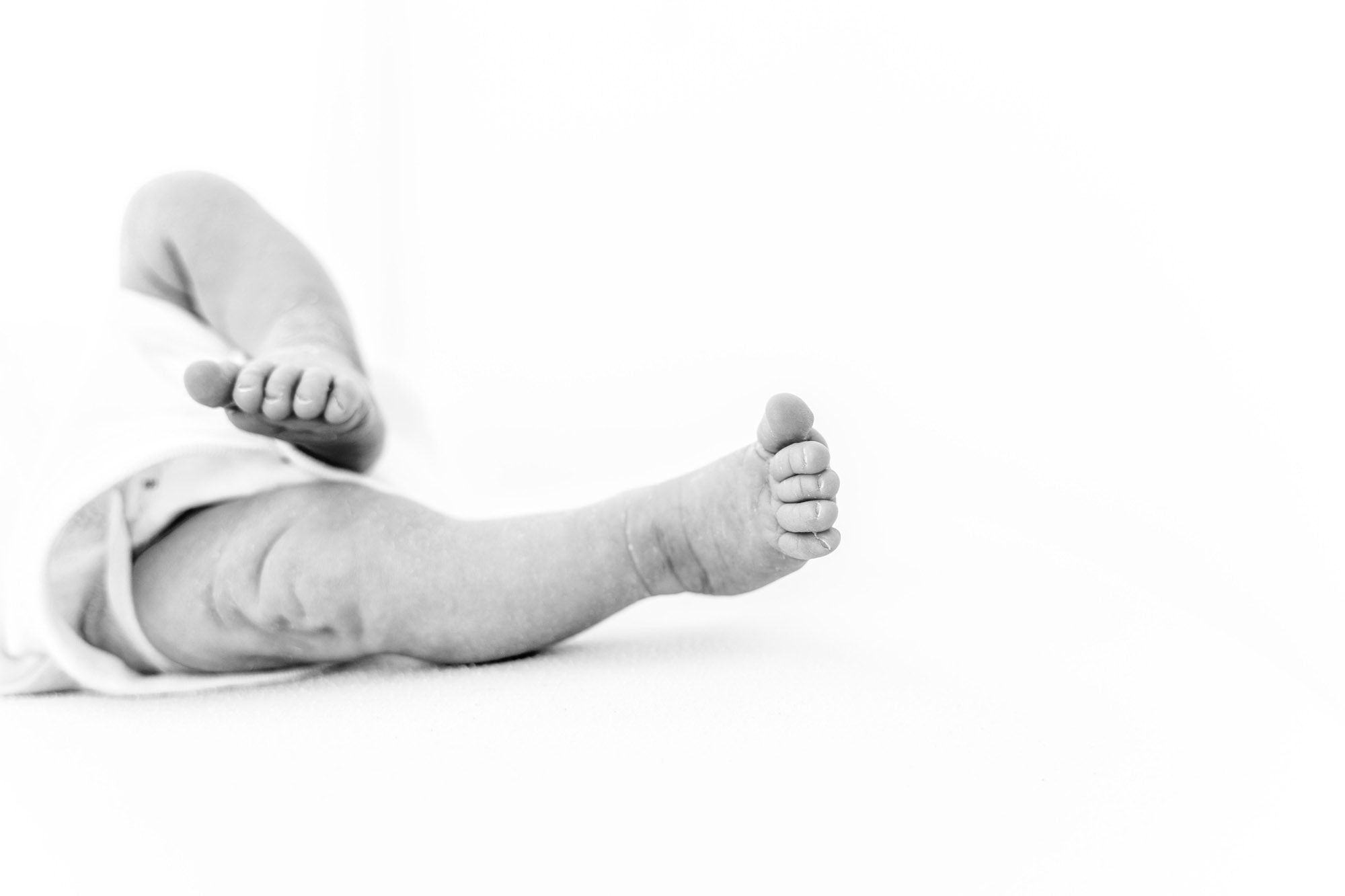 image of baby stretching out their feet taken by newborn photographer norwich
