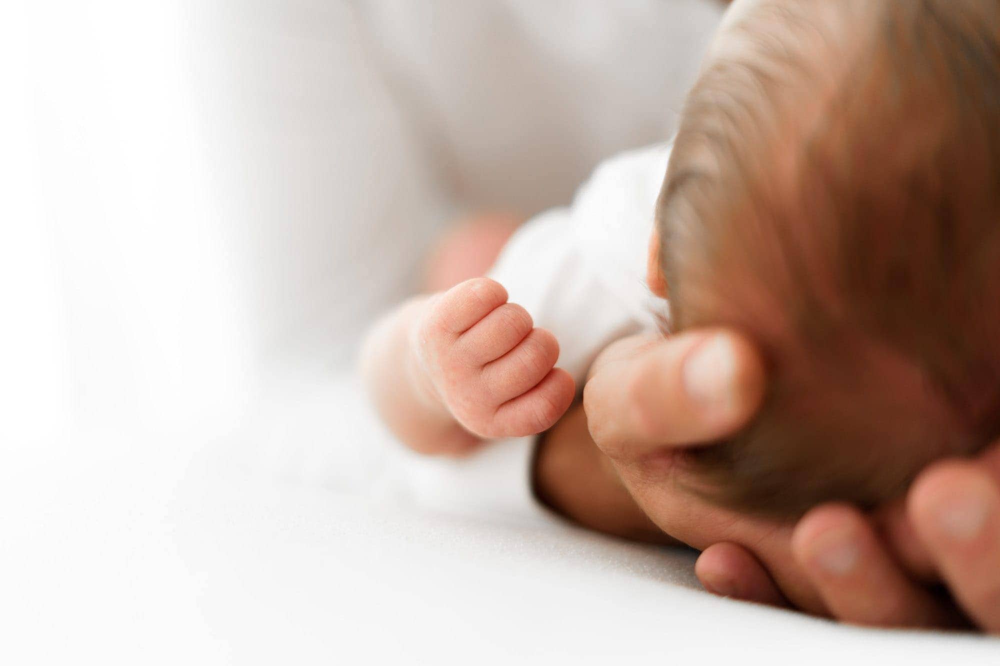 close up of newborns closed fist taken during newborn photoshoot norwich